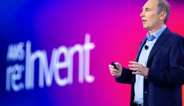 AWS re:Invent 2020 keynote speaker presenting latest AWS announcements on stage.